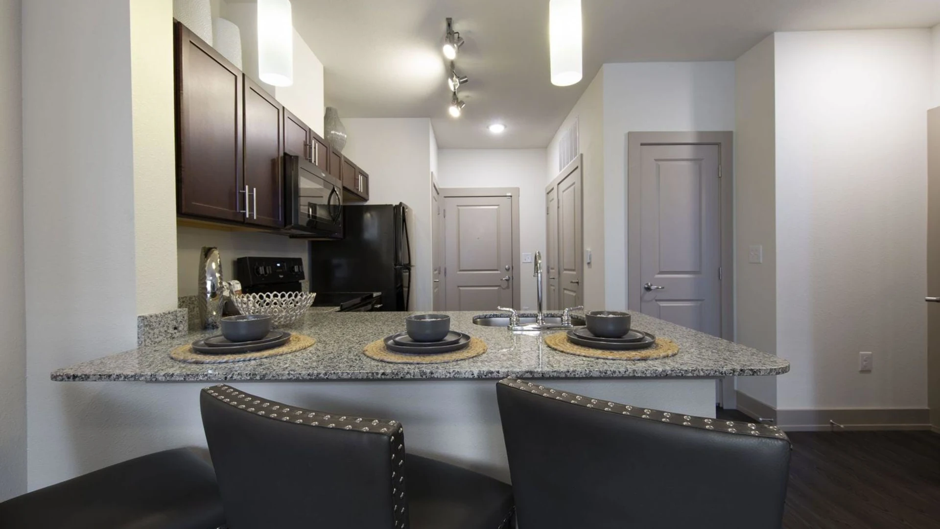 kitchen with granite counter tops and stainless steel appliances at The Steelyard Apartments