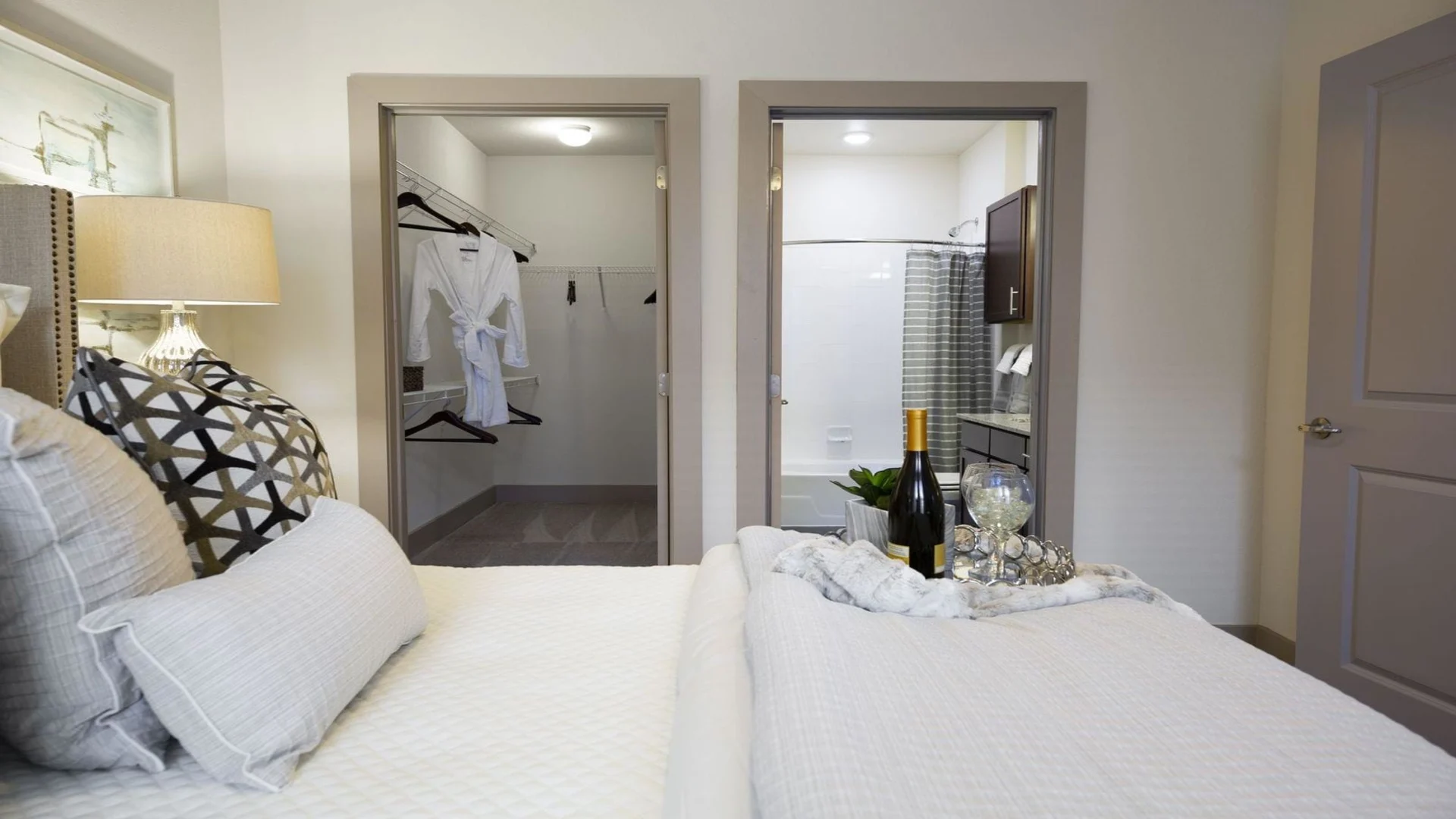 a bedroom with a bed and a bathroom at The Steelyard Apartments