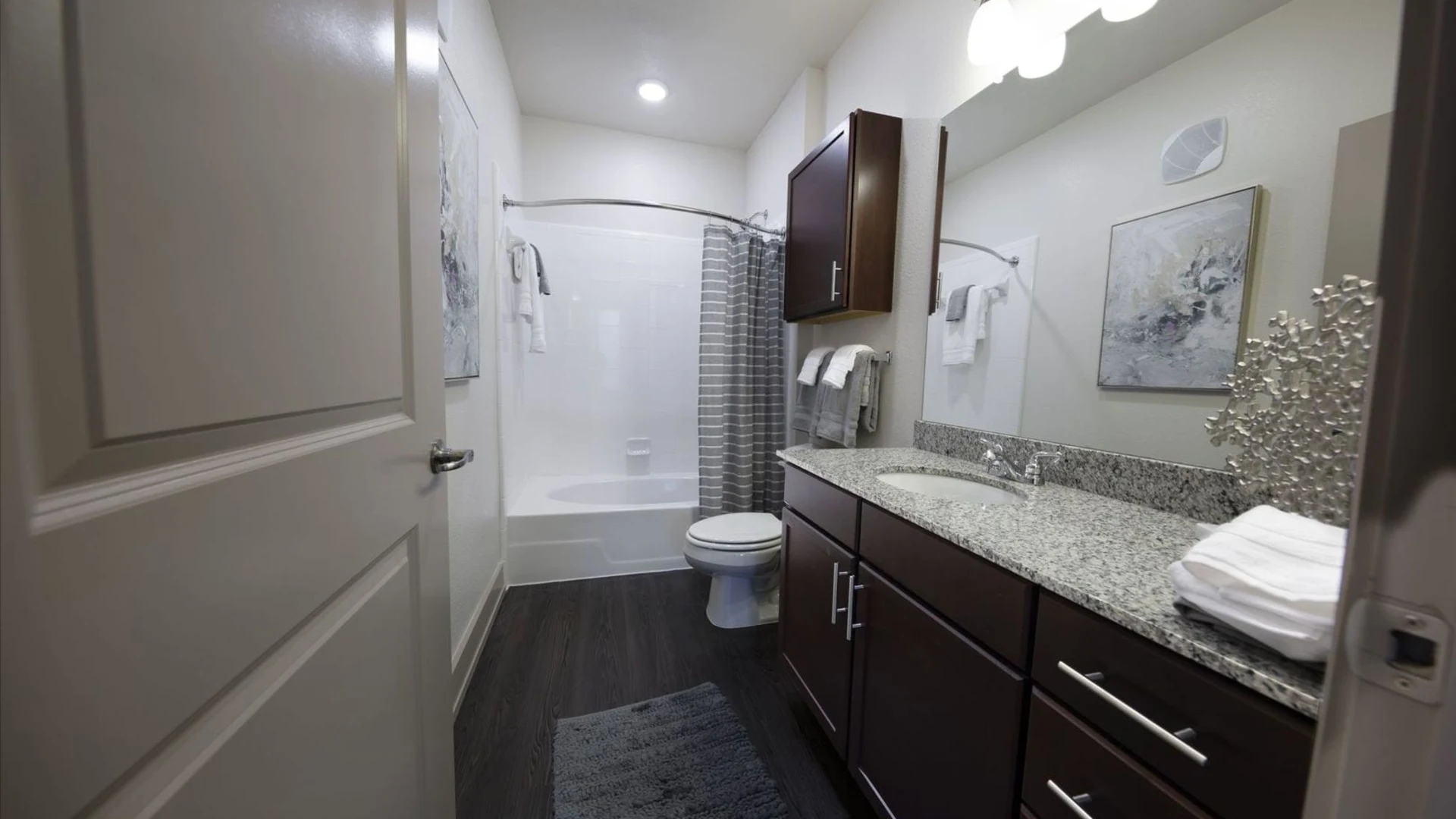 a bathroom with a sink, toilet and shower at The Steelyard Apartments