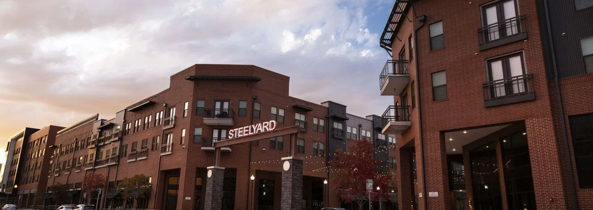 the building is made of brick and has a red brick facade at The Steelyard Apartments