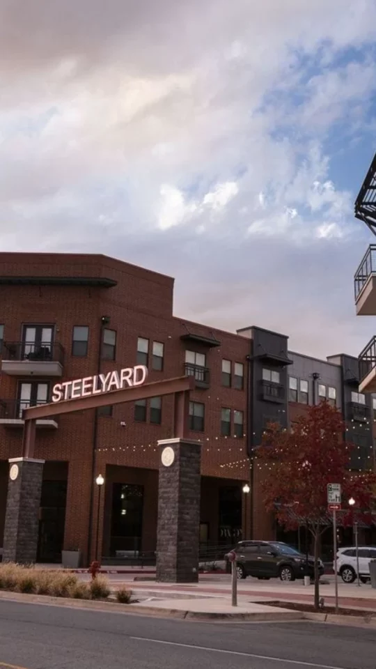 the building is made of brick and has a red brick facade at The Steelyard Apartments