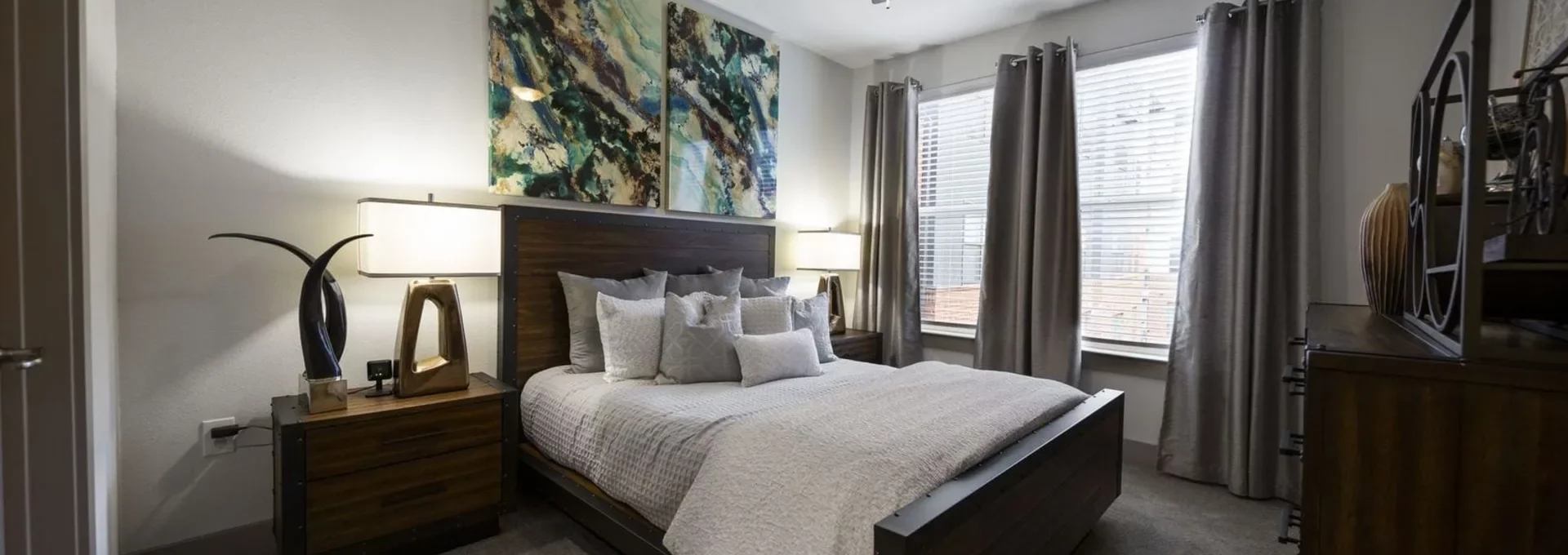 a bedroom with a large bed and ceiling fan at The Steelyard Apartments