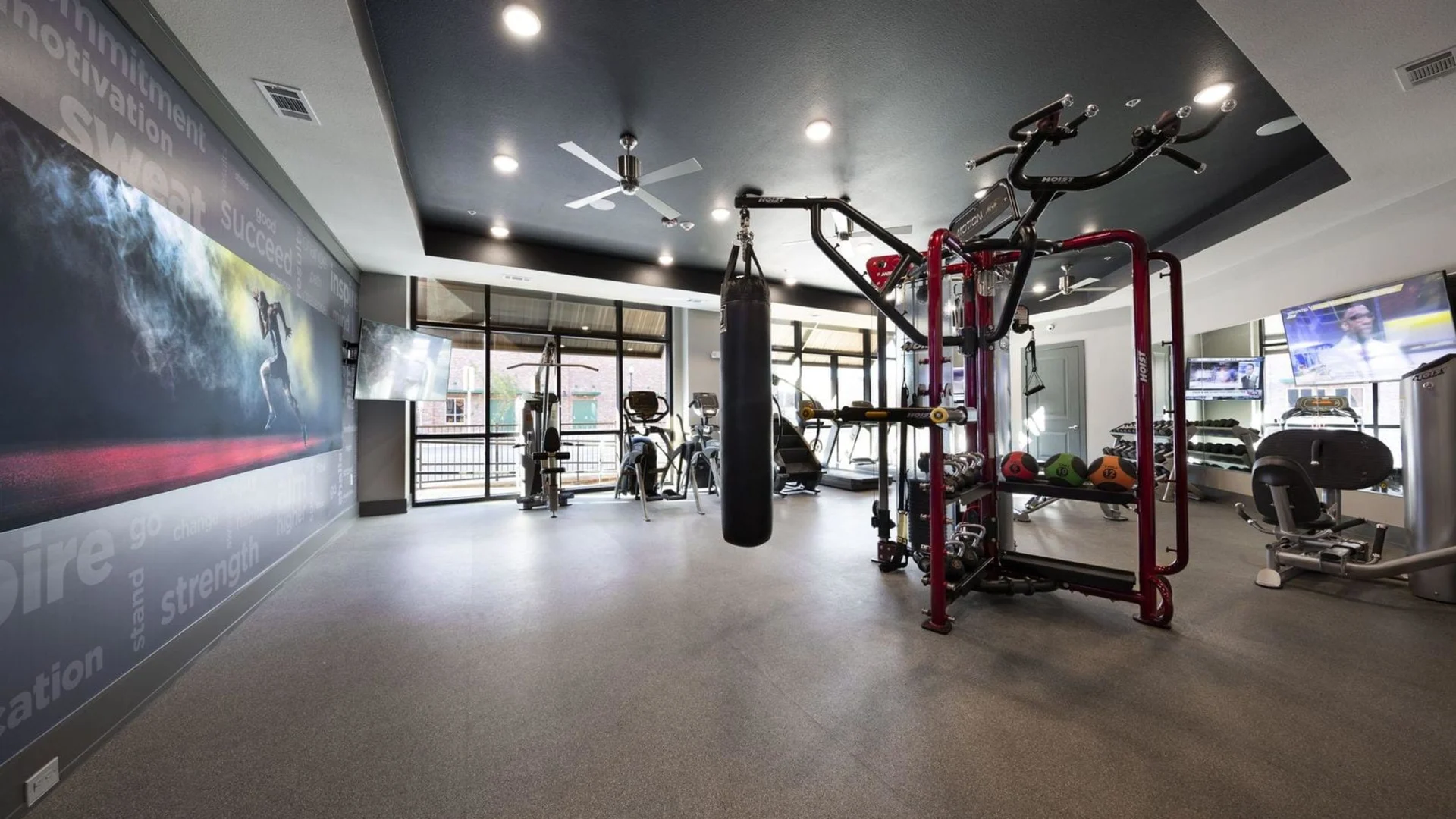 a gym room with a treadmill and exercise equipment at The Steelyard Apartments
