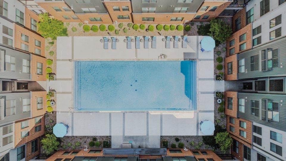 an aerial view of a pool in a courtyard at The Steelyard Apartments