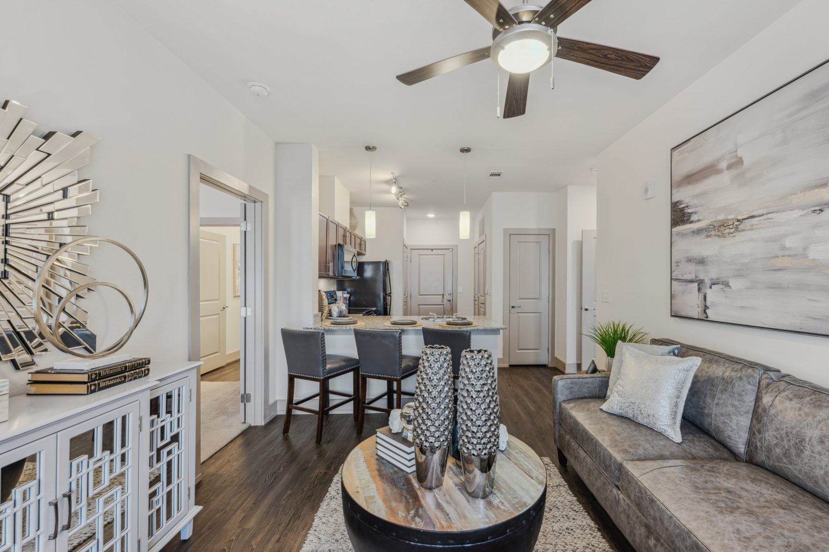 the living room has a ceiling fan and a couch at The Steelyard Apartments